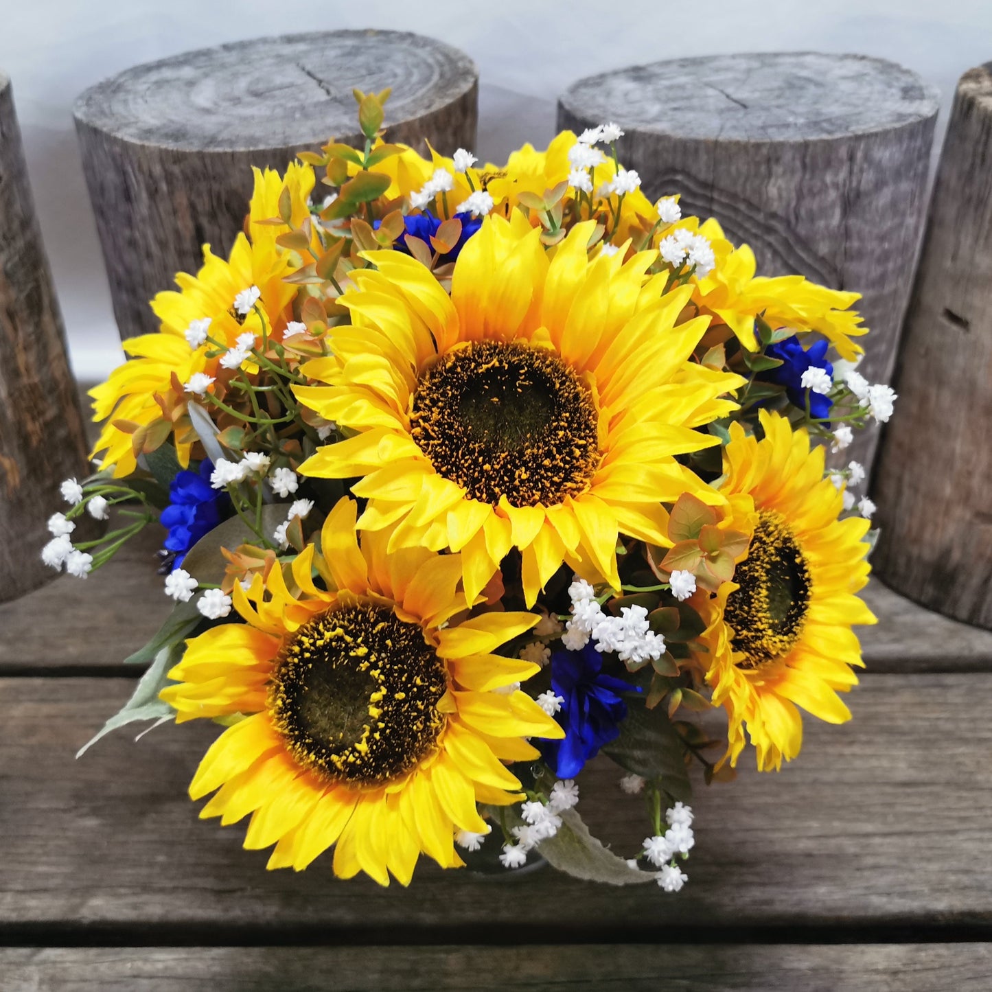 Bouquet of sunflowers and blue flowers 