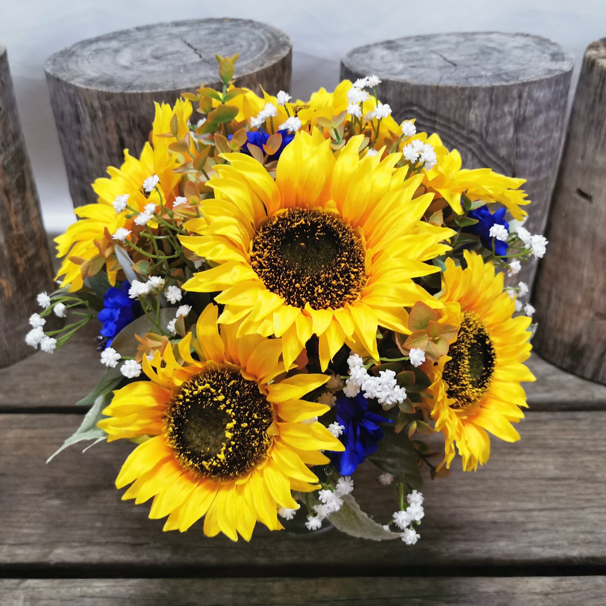 Bouquet of sunflowers and blue flowers 