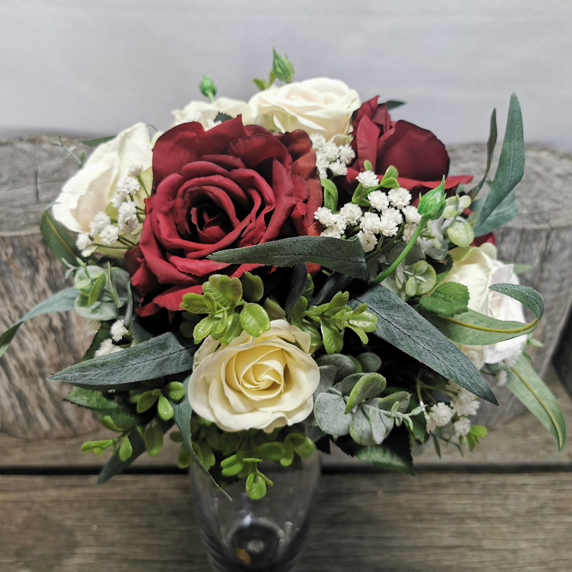 Bouquet of red and white roses with greenery